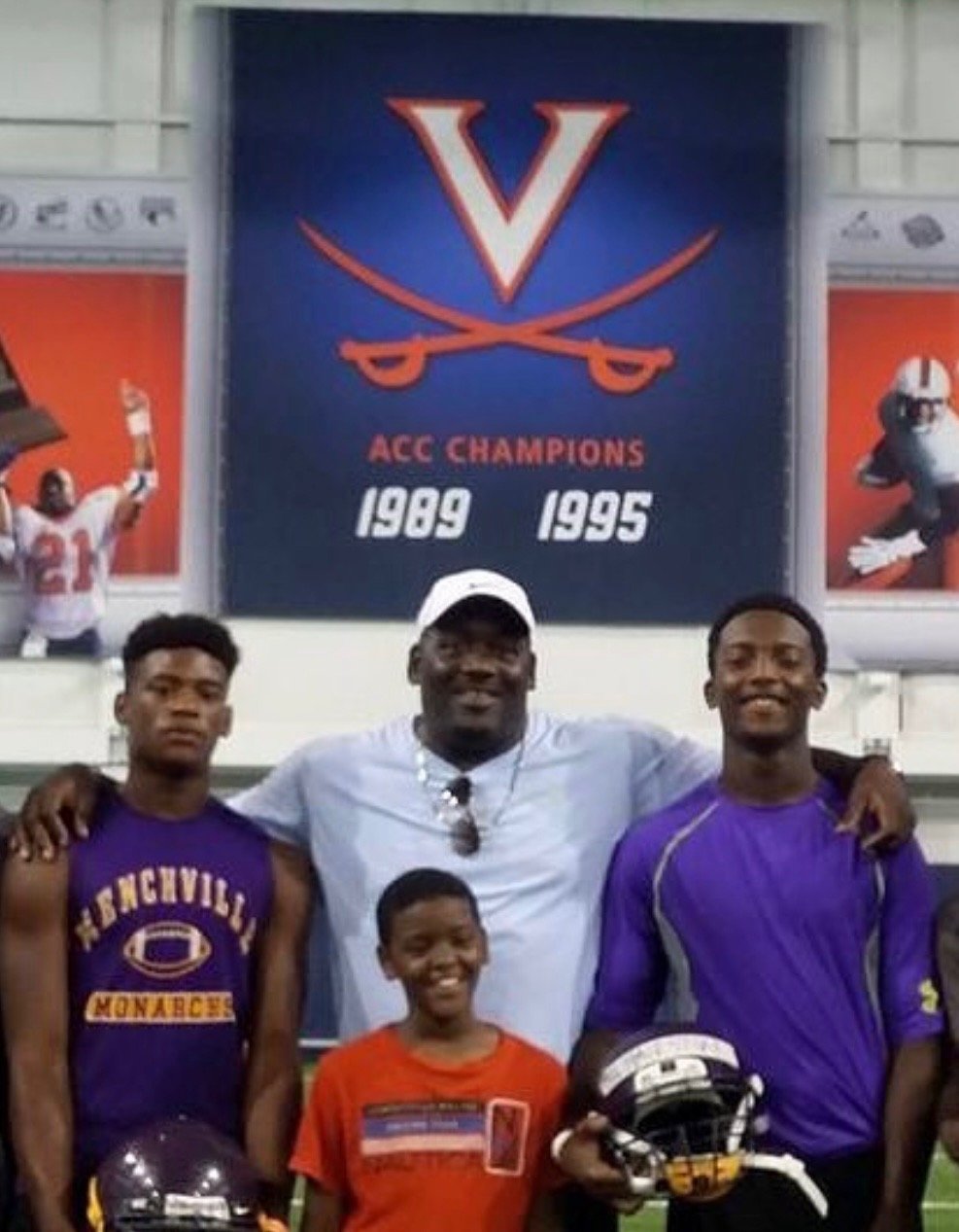 Raymond Savage Jr. mentoring a young football player